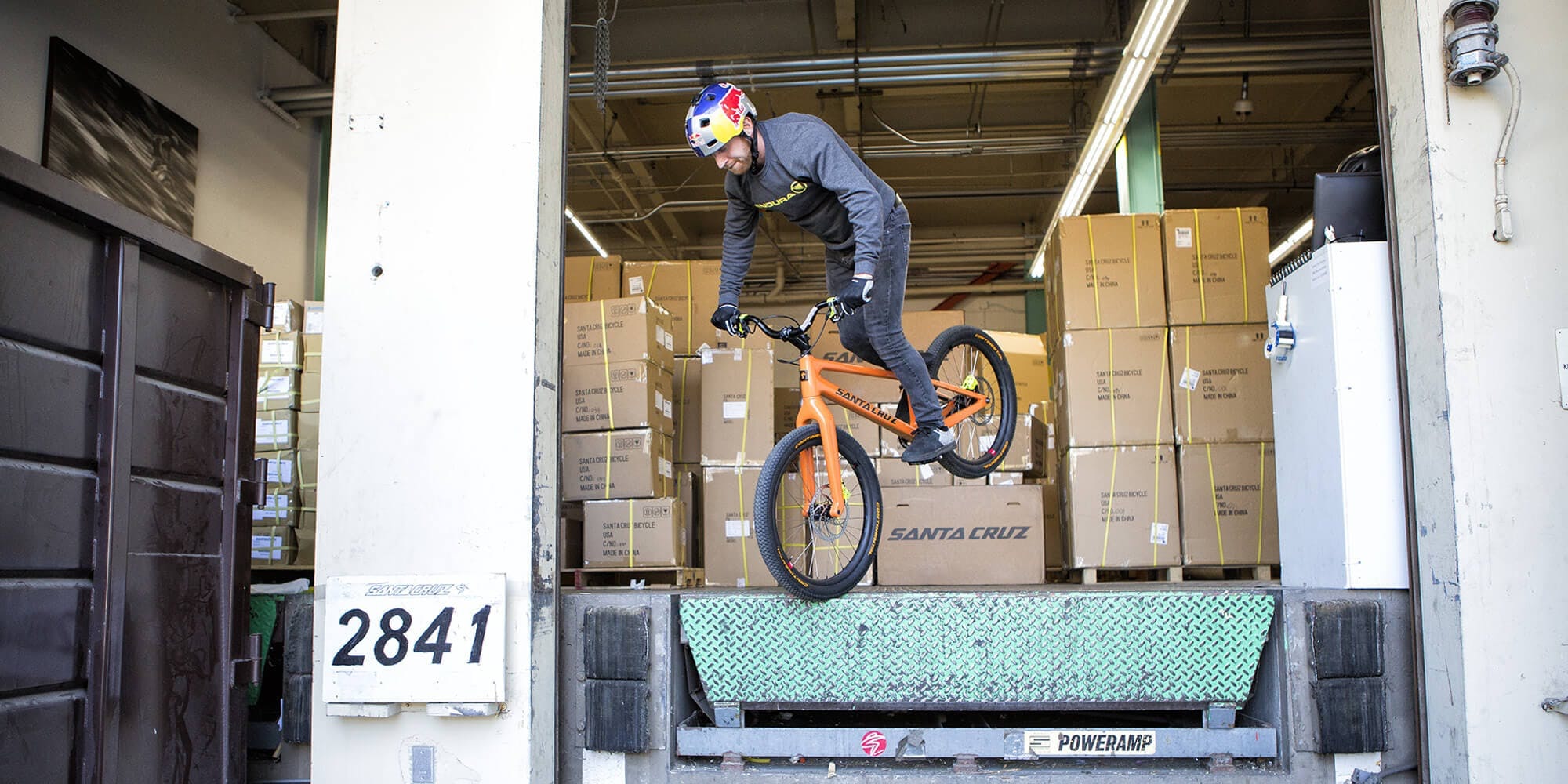 Danny MacAskill riding off a ledge on his Santa Cruz carbon trials bike