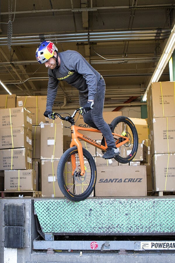 Danny MacAskill riding off a ledge on his Santa Cruz carbon trials bike