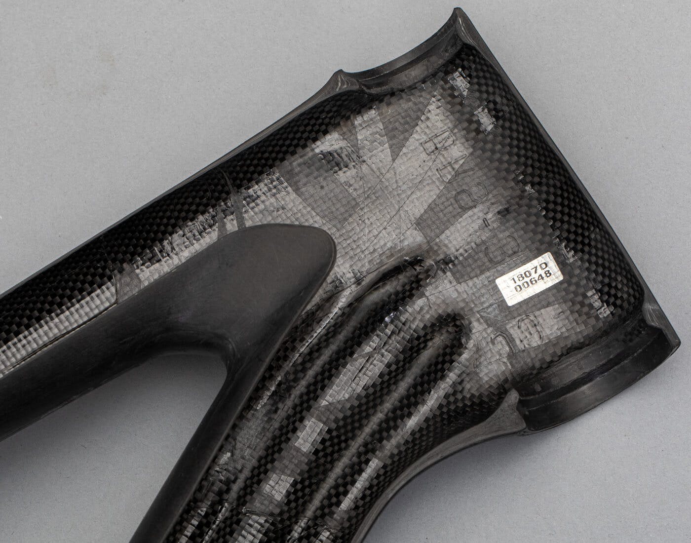 A carbon bicycle frame cut in half to expose the inner carbon cable routing